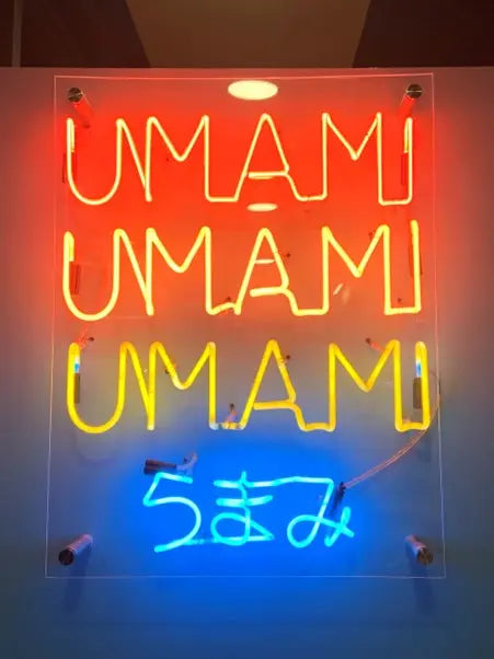 Picture of the word  'umami' in lights