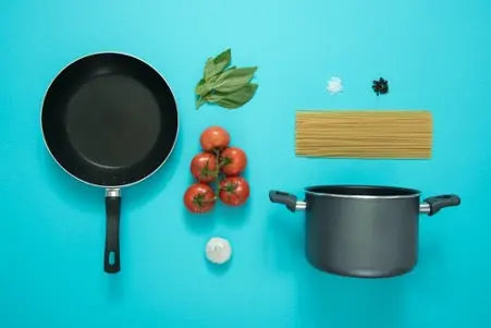 picture of frying pan, saucepan, pasta and herbs